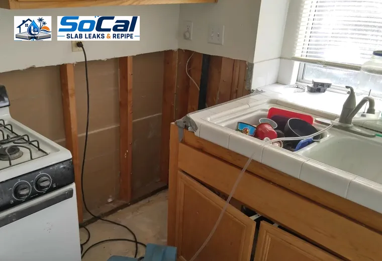 Burst pipe repair and general plumbing access in kitchen wall